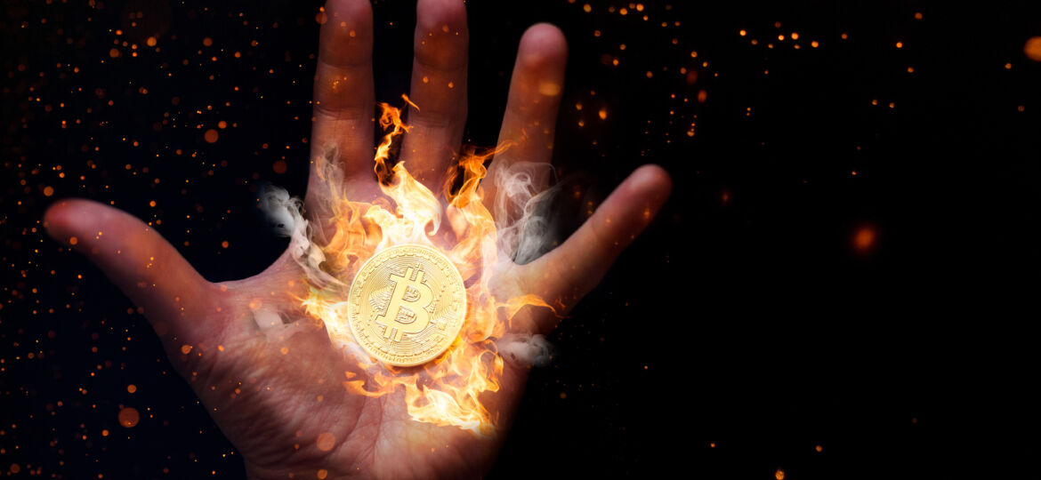 Human,Hand,With,A,Burning,Bitcoin.
