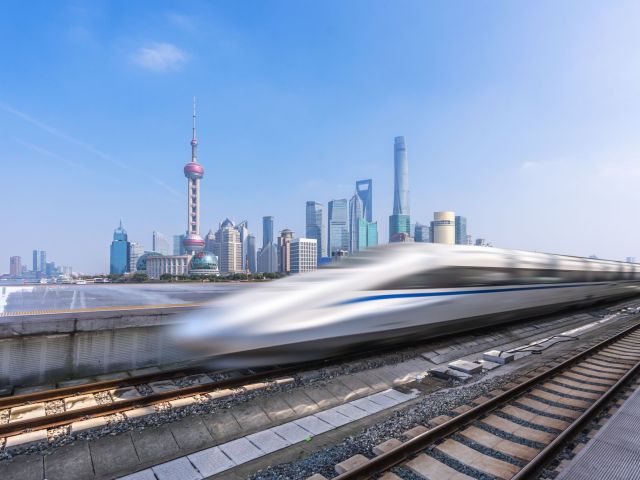 High,Speed,Train,With,Modern,Building,In,China